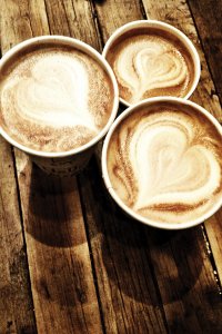 Ariel view of three lattes with hearts in the foam.