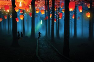 Glowing lanterns in a dark forest with children playing in front of a house.