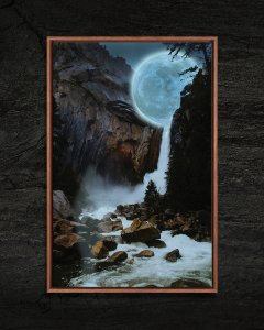 The moon on top of a waterfall flowing into a stream.