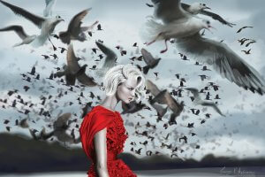 Profile of a woman in an elegant red dress as a mass of seaguls fly behind her.