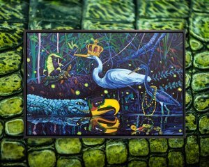 Blue herons, alligators, frogs, and turtles wearing mardi gras costumes in a swamp