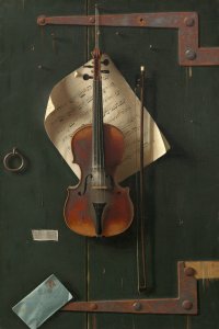 An old violin hanging against a vintage trunk with a bow and some sheet music.