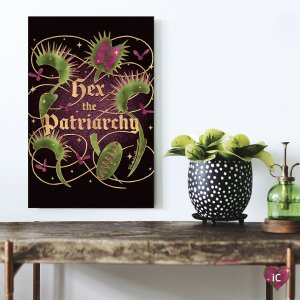 The phrase "hex the patriarchy" in gold surrounded by venus fly trap plants.
