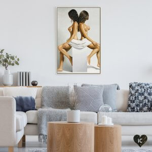 Two nude twins sitting back to back on a white column on a white background.