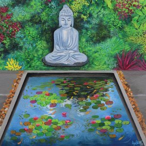 Buddha statue by a garden pond surrounded by plants