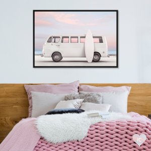 White van and surfboard in front of pink and blue sky
