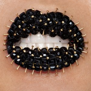 Black studded lips with gold pins