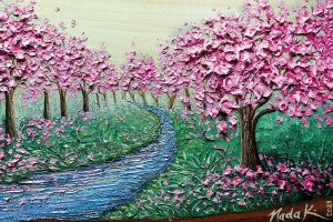 NKH2 Pink flowering trees with river running through them and green grass surrounding