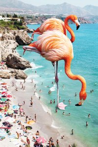 Two giant flamingos on the beach surrounded by people