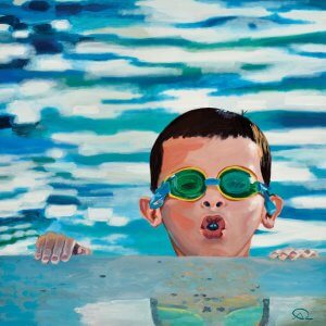 Young boy with goggles popping head out of water
