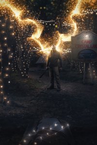 Jason Voorhees of Friday the 13th standing with fire coming out of his back surrounded by string lights at Camp Crystal Lake