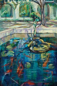 Fountain full of Koi fish and lily pads with trees in the background