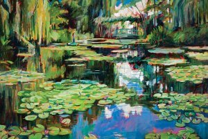 Pond full of lily pads surrounded by trees and a bridge