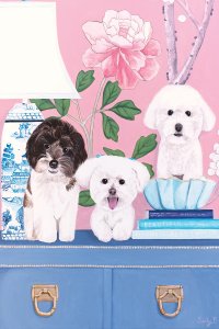 Three dogs sitting on a dresser with a lamp and books in front of a pink flower wall