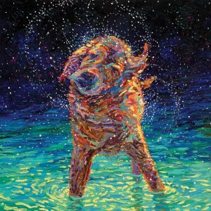 Yellow lab shaking water out of its fur while standing in a body of water