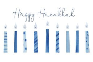 8 blue lit candles underneath the words Happy Hanukkah