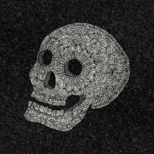 A skull made of intricate patterns against a dark background