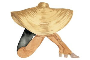 A woman wearing a black bathing suit sitting down with an oversized sunhat