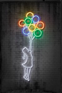 Little girl in neon dress holding a group of colorful balloons