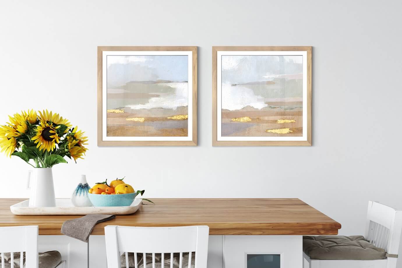 minimalist art prints hanging above kitchen table