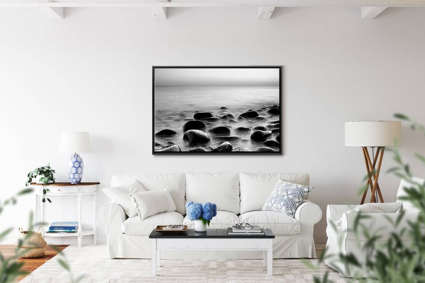 black and white ocean photo above couch