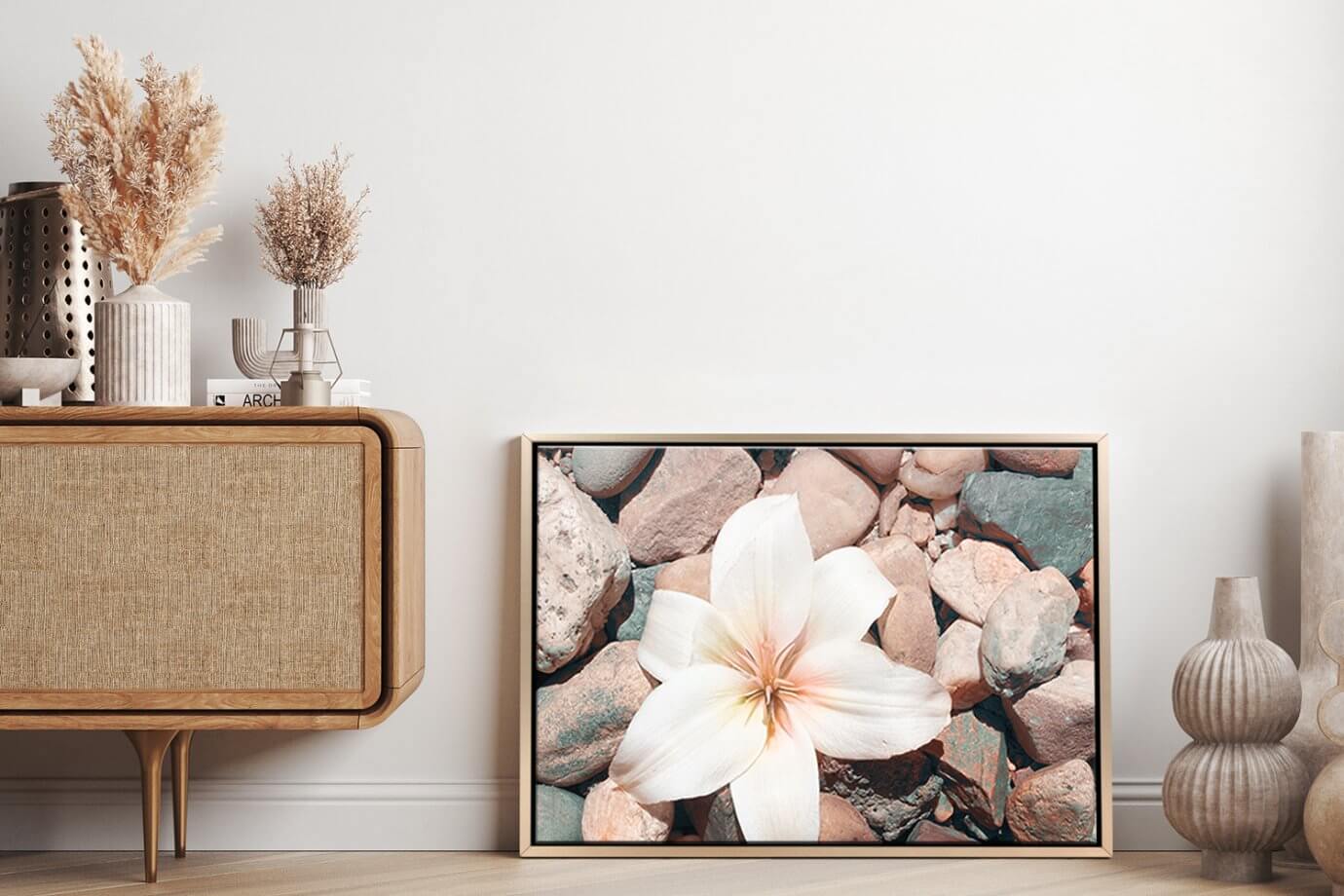 flower and rocks artwork leaning against wall