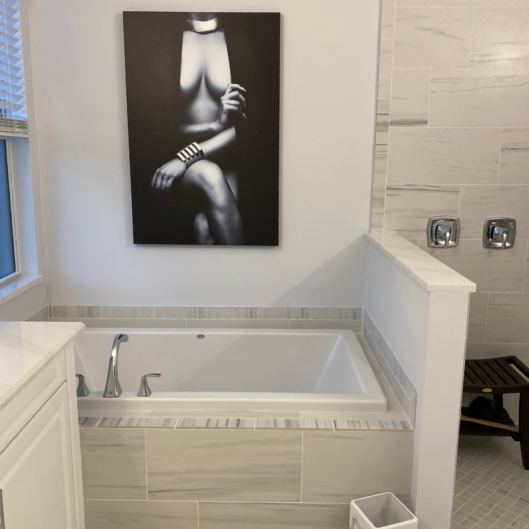 black and white woman art above bathtub