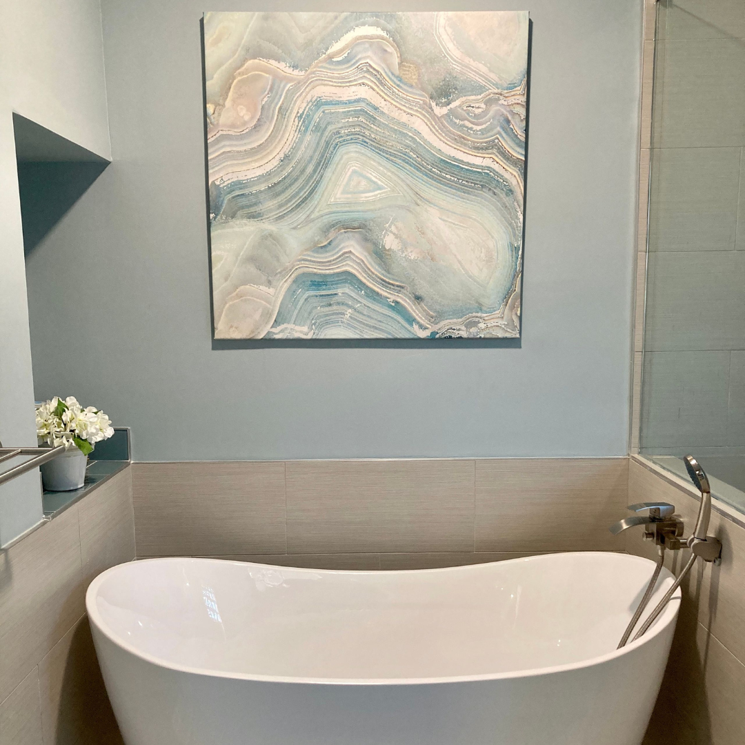 blue abstract painting above bathtub