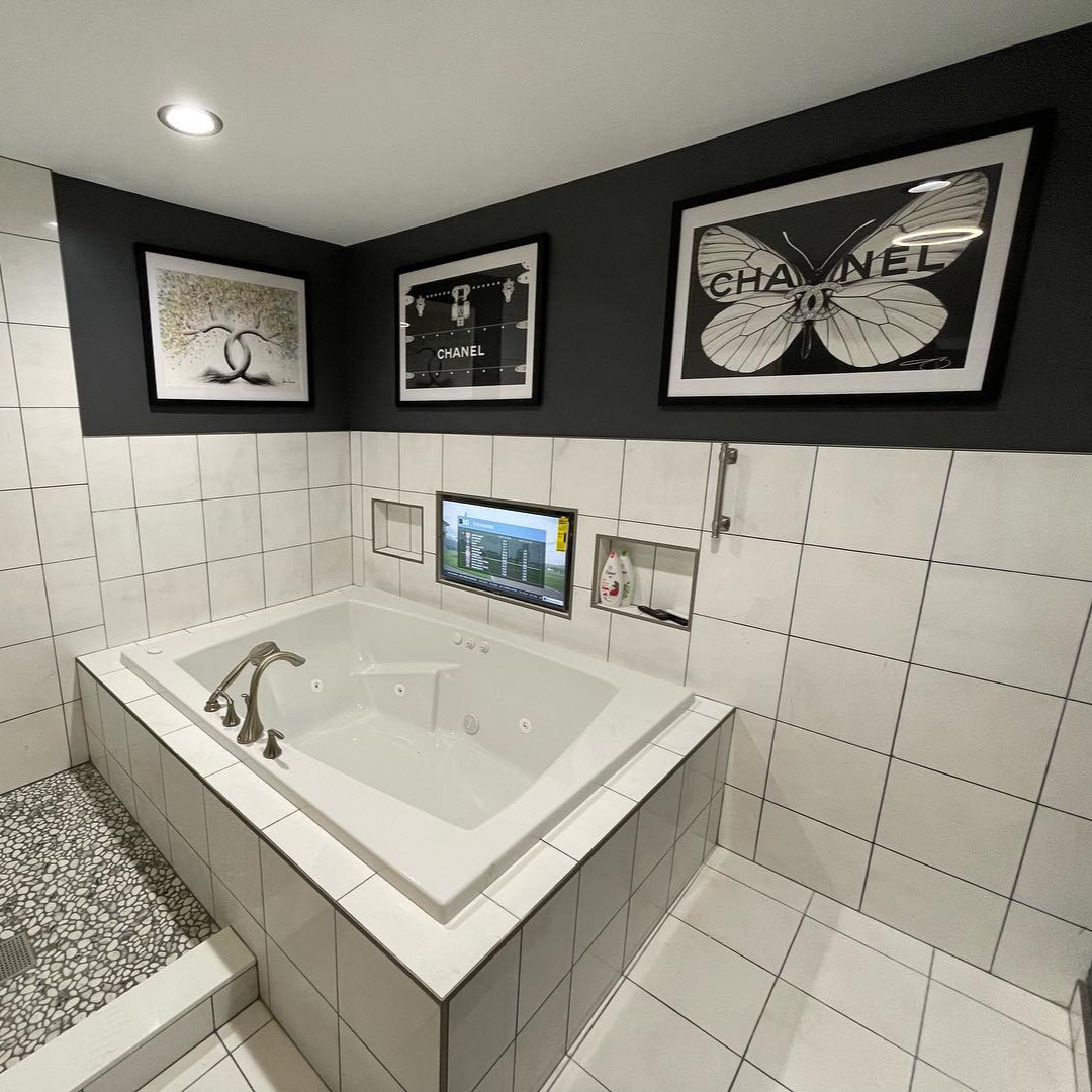 black and white chanel art above bathtub