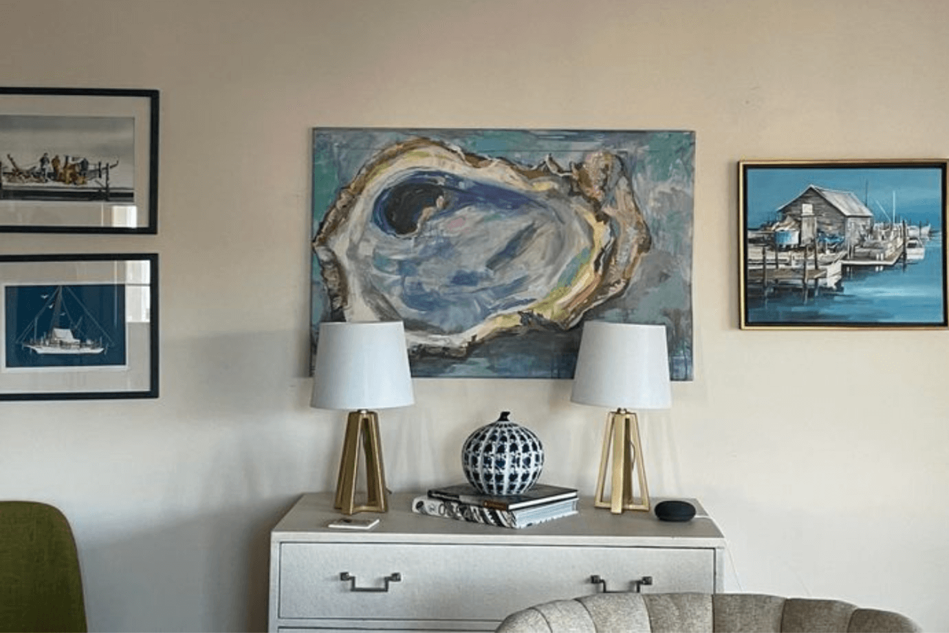 oyster art surrounded by sailboat and coastal prints