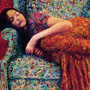 woman in orange dress relaxing on a multicolored chair