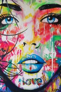 portrait of a woman with blue lips and colors splattered on her face