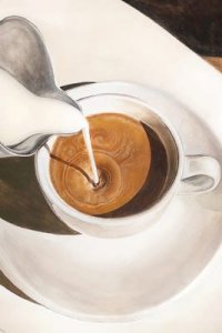 cream being poured into a cup of coffee in white mug
