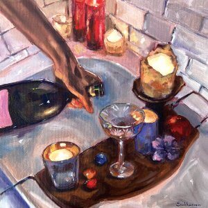 person pouring wine into a glass sitting on a table in a bathtub with candles