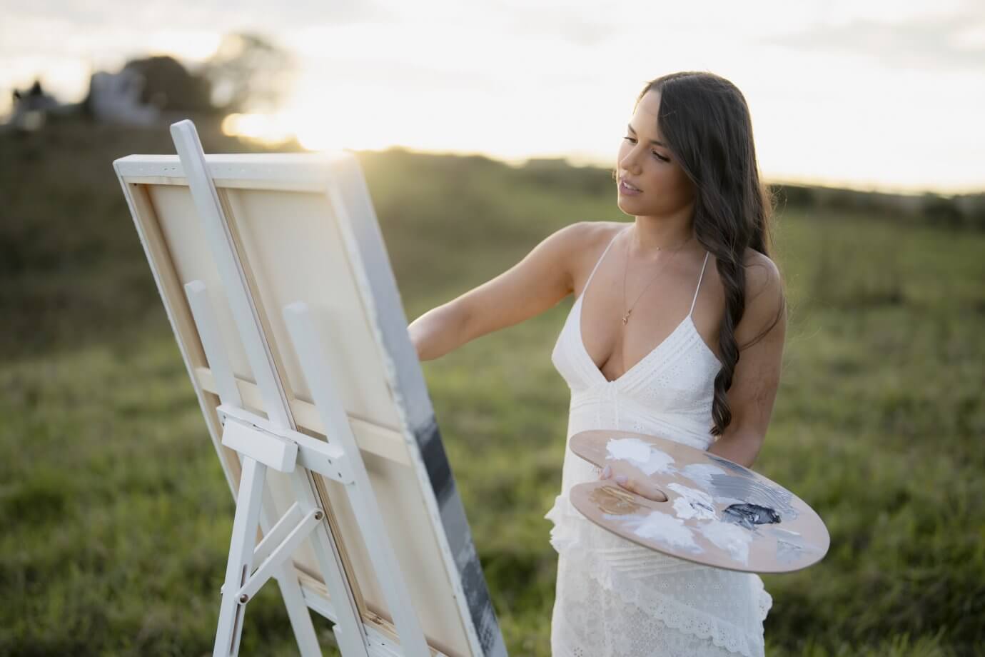 isabella karolewicz artist painting on a canvas outside