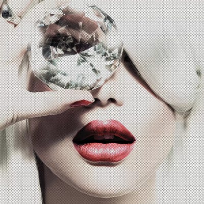 woman holding diamond over eye