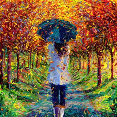 woman walking through fall forest with umbrella