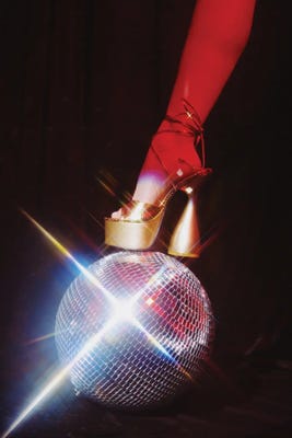high heel stepping on shiny disco ball