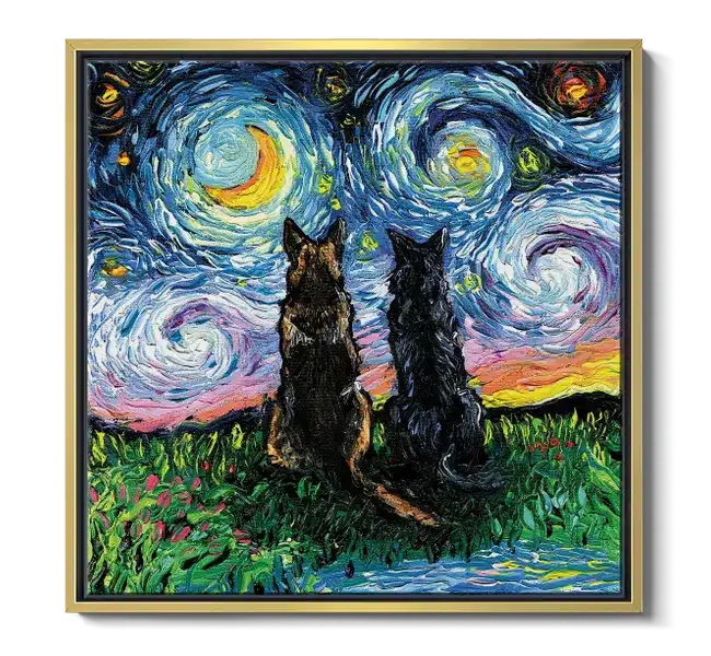 Two german shepherds sitting the grass facing towards a swirly nighttime sky