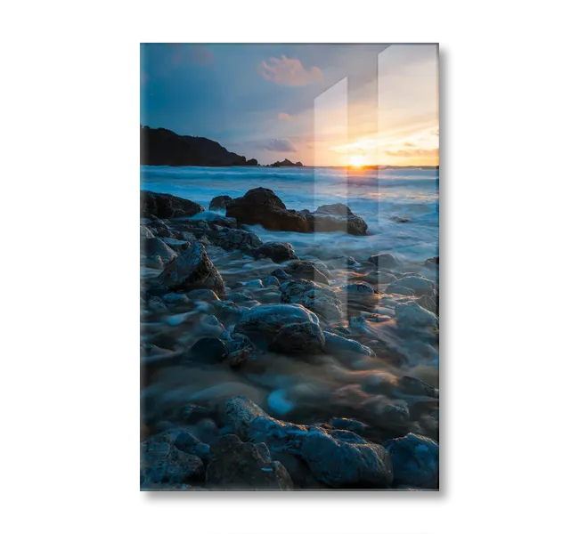 Sunset over ocean with rocks