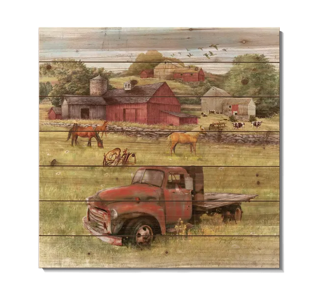 Red barn and red truck in a field with horses