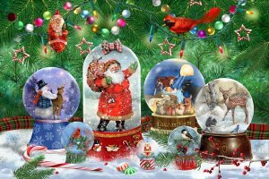 christmas themed snowglobes in front of a christmas tree