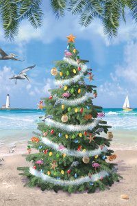 christmas tree on a beach with the ocean in the background