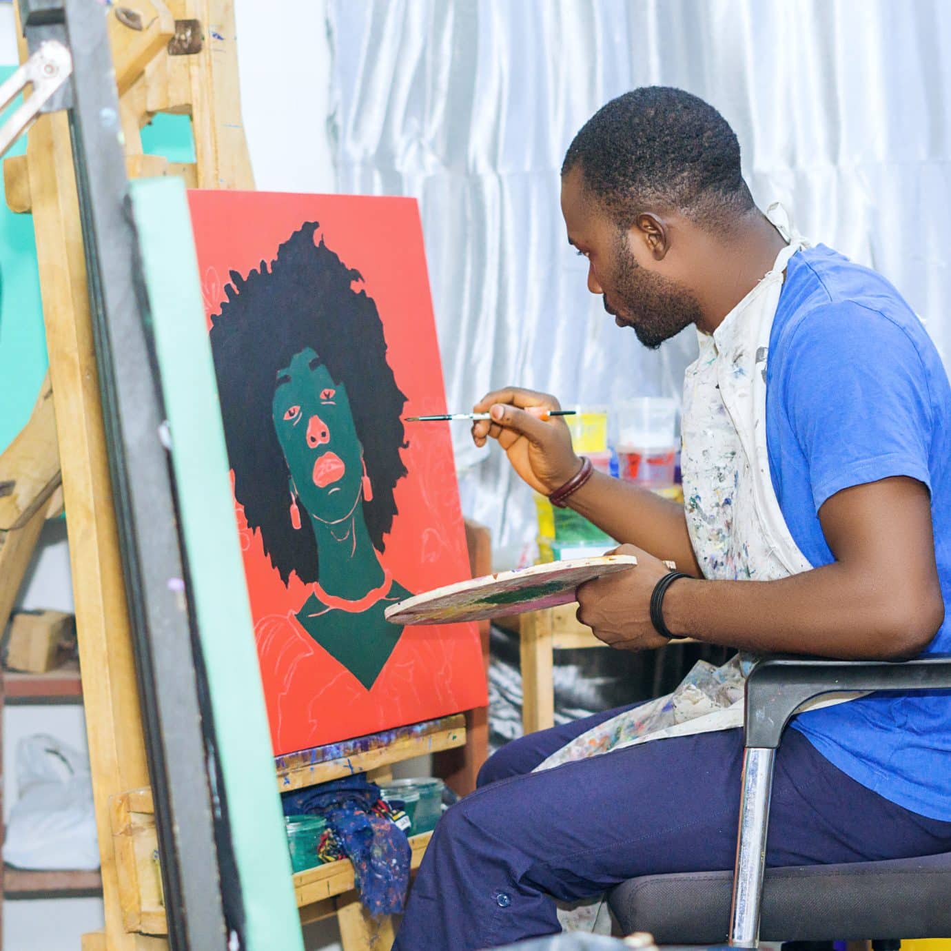 nigerian artist Oluwafemi Afolabi working on a painting