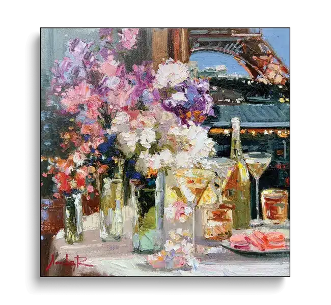 tablescape with glasses of wine, flowers, in front of eiffel tower