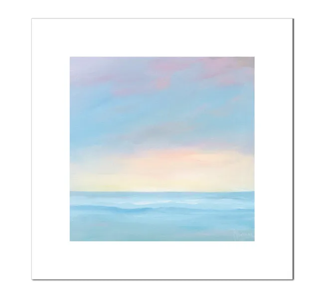 pastel colored sunrise over water