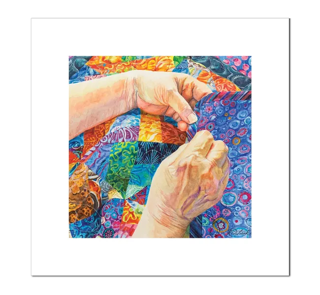 hands sewing a colorful blanket