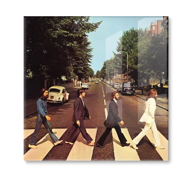 group of four men walking on crosswalk across a street