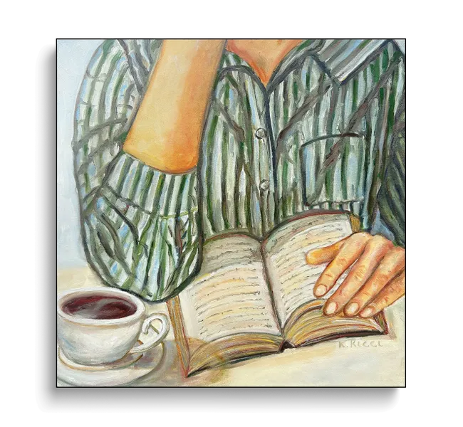 person wearing striped green and white shirt holding a book next to a cup of coffee
